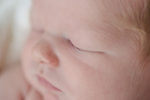 Newborn details baby boy face close up photo