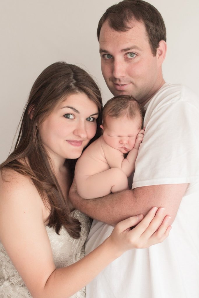 Mom Dad and newborn cuddle First moments brand new baby boy photo Gainesville Florida