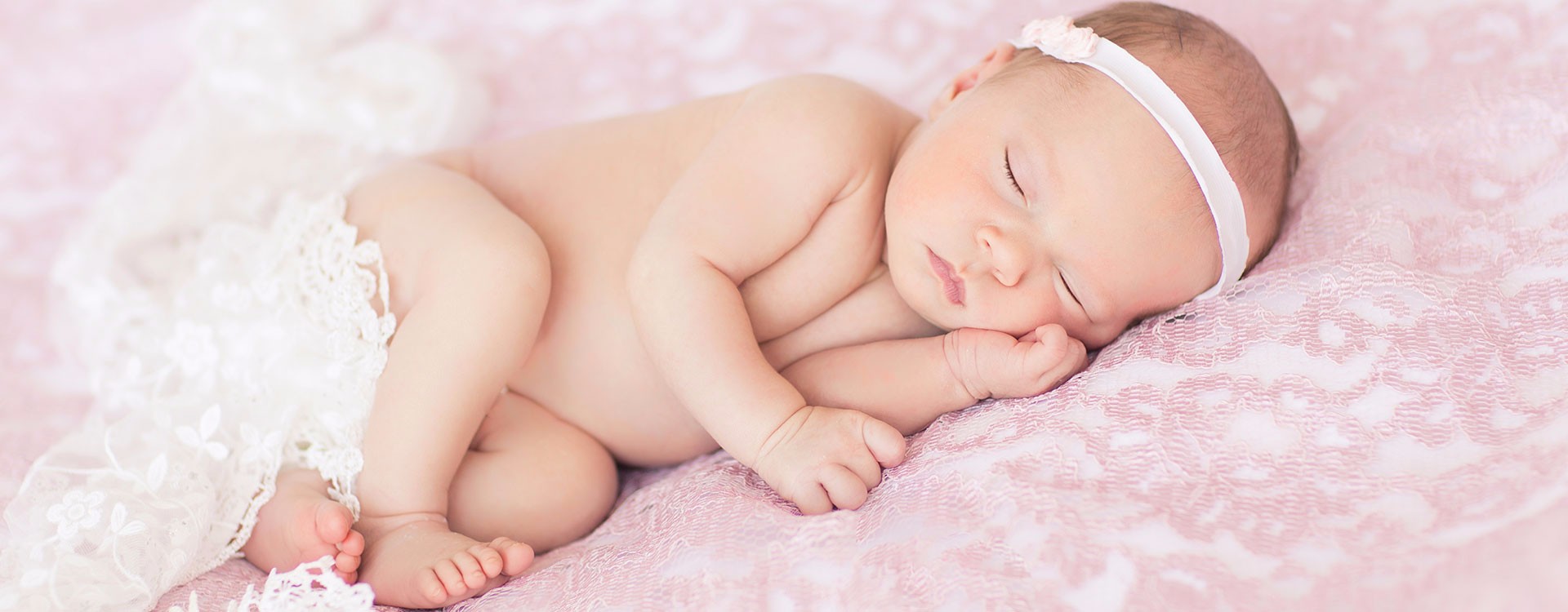 Beautiful Newborn girl posed on pink lace with with pretty baby lips and baby eye lashes Gainesville Florida photo