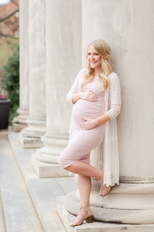 Maternity mom looking beautiful in outside photo session with white pillars