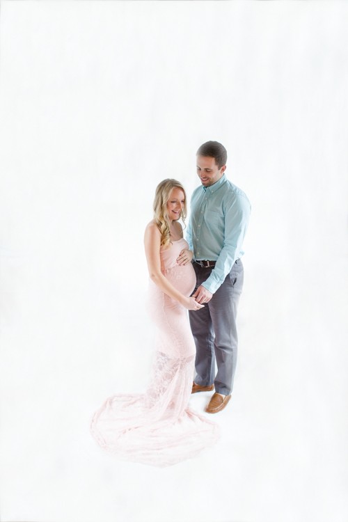 Mom and dad formal maternity photos on white backdrop Gainesville Florida