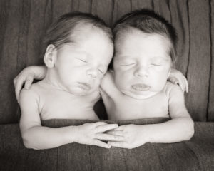 Newborn Twin Boys posed with a hug taken in Gainesville, Florida