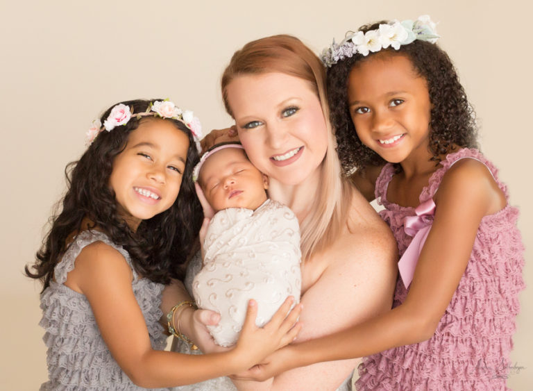 Mom and her delightful and beautiful girls with newborn