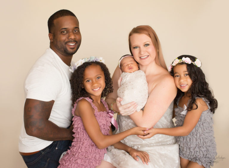 Happy newborn family with three girls Gainesville Florida