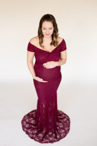 April in Lace Burgundy Maternity Gown Glancing at her Round Belly Gainesville Florida