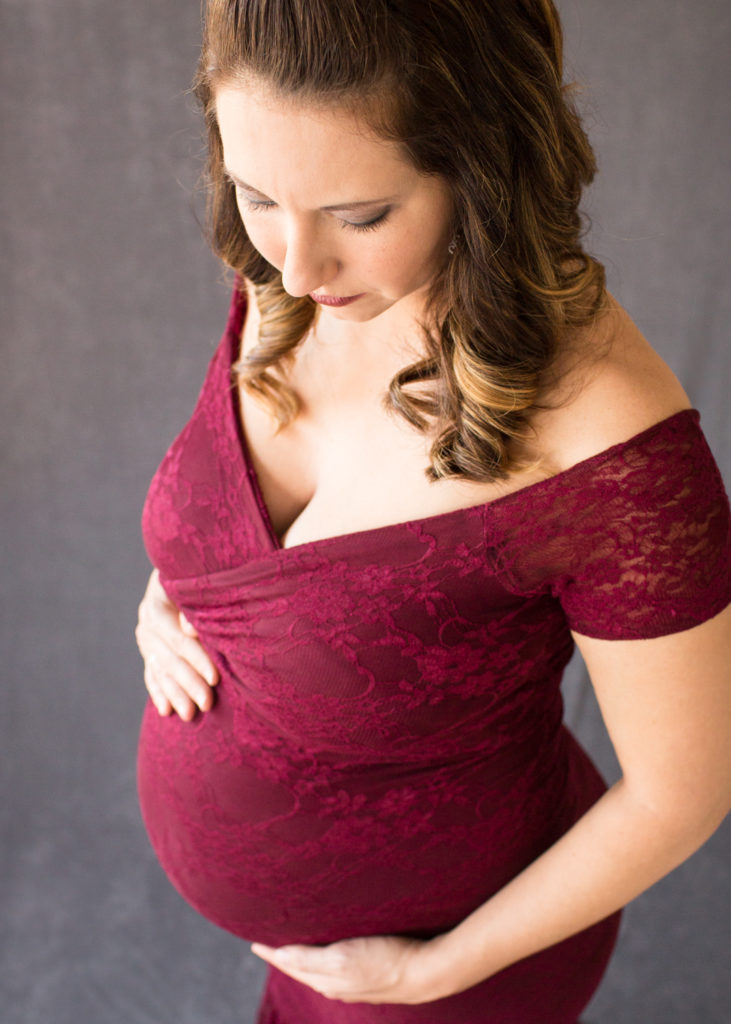 April with Maternity photos in burgundy lace gown carrying Twin girls in Gainesville Florida-1