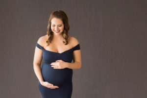 April in Maternity photos with navy gown carrying Twin girls in Gainesville Florida-18