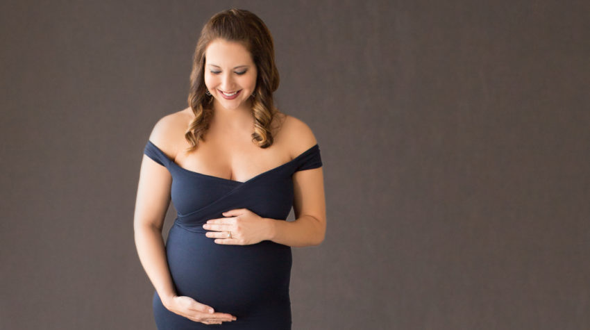April in Maternity photos with navy gown carrying Twin girls in Gainesville Florida-18