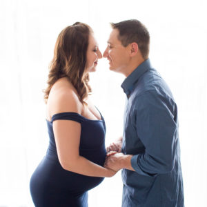 April and James back lit Maternity photos in navy gown carrying Twin girls in Gainesville Florida-4