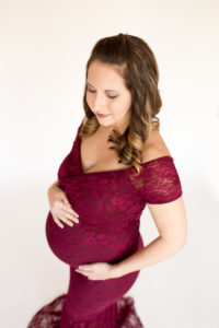 April with Maternity photos in burgundy lace gown carrying Twin girls in Gainesville Florida-9