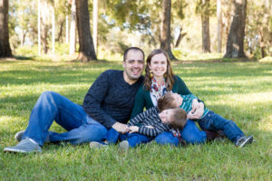 Family photo session at park with two year old twin boys laughter