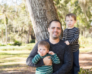 Family photo session at park with shy two year old twin boys