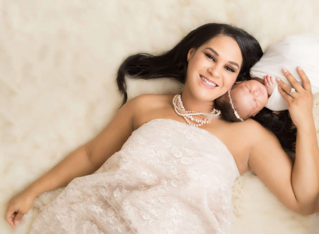 Babygirl with glamorous mom in Newborn Photosession on cream fur