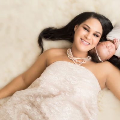 Babygirl with glamorous mom in Newborn Photosession on cream fur