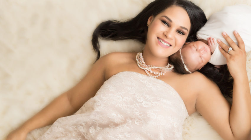 Babygirl with glamorous mom in Newborn Photosession on cream fur