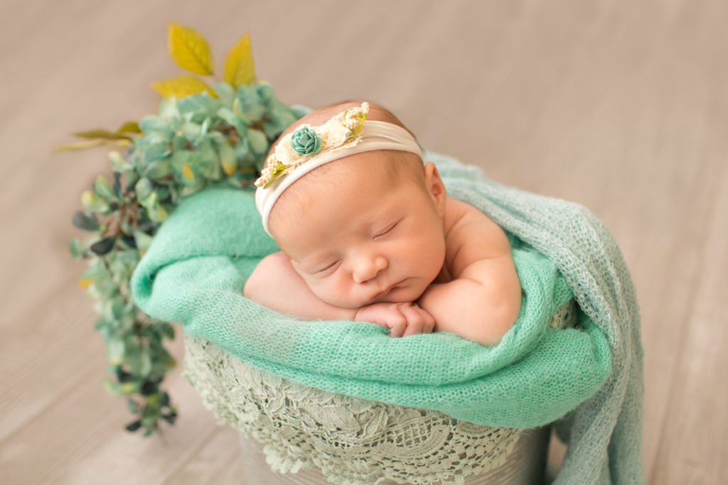 Baby girl Charleigh all wrapped up in bucket with aqua lace and flowers in Gaineville Florida