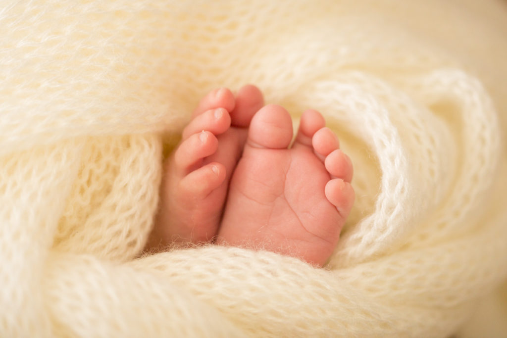 Baby girl Charleigh feet and toes wrapped in cream in Gainesville Florida