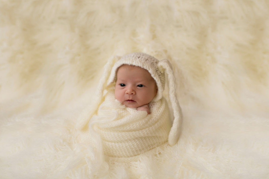 Baby girl Charleigh potato sack and bunny bonnet on cream fur in Gainesville Florida