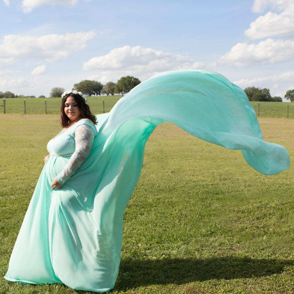 Maternity pale mint green gown tossed in wind outside photos in Alachua Florida