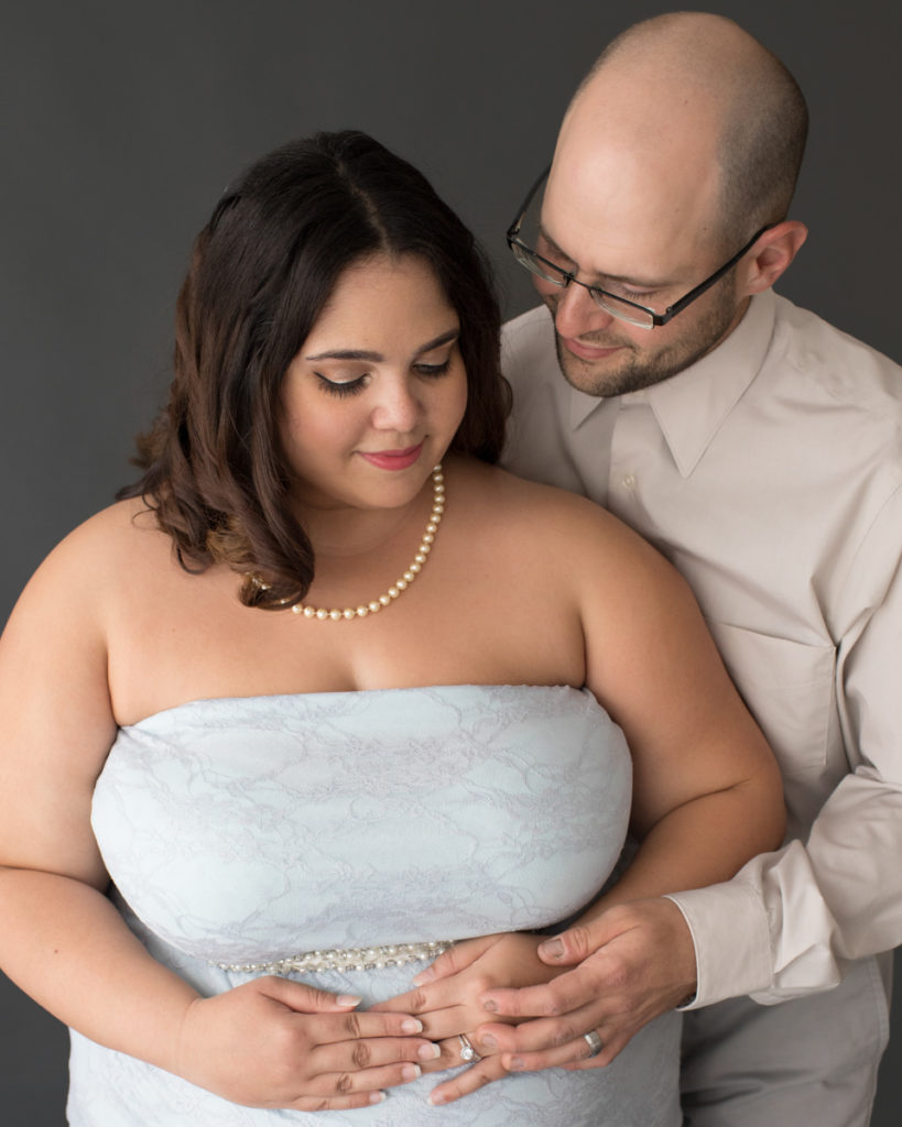 Maternity Indoor Photos of Pregnant Adelis in Blue Lace gown and Pearls with husband in Alachua Florida