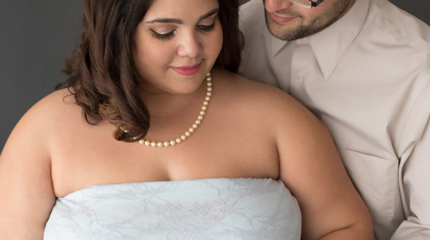 Maternity Indoor Photos of Pregnant woman in Blue Lace gown and Pearls with husband gazing at her in Alachua Florida