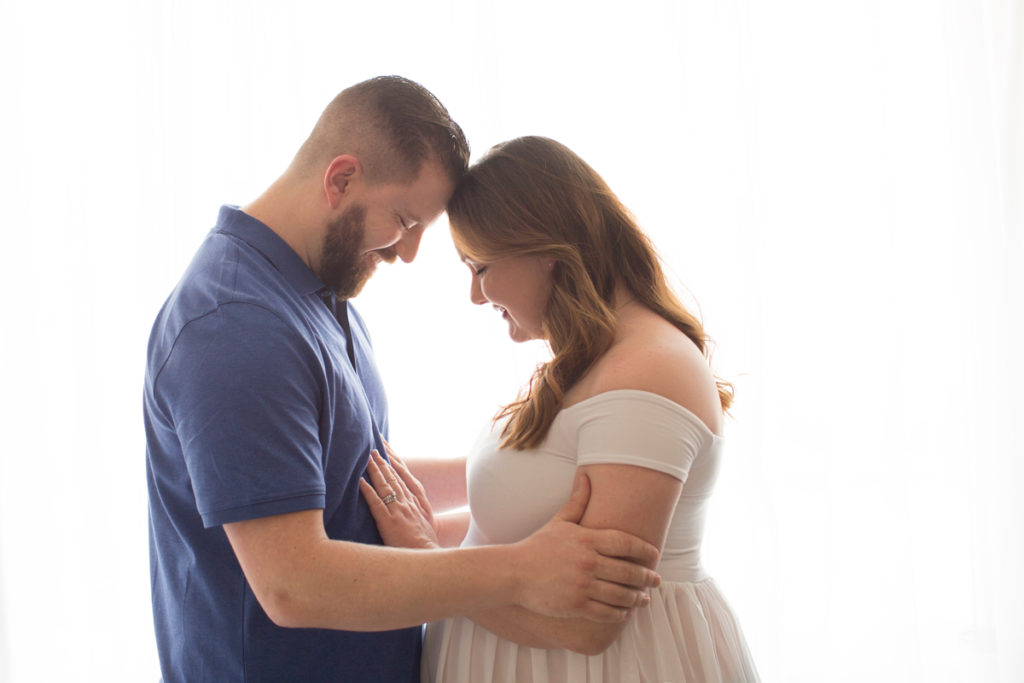 Maternity photo Nick and Janet love their baby with backlight in Gainesville Florida