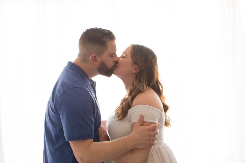 Maternity photo Janet and Nick kiss with backlight in Gainesville Florida