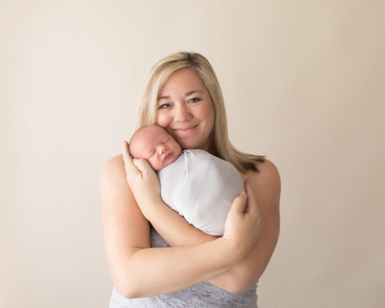 Photo mom in grey lace tenderly loving with tears of joy her newborn baby in grey knit pictures Gainesville Florida