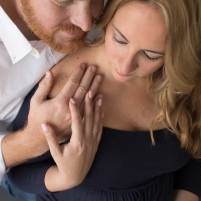 Dads tender embrace of pregnant mom viewed from above looking down at thier loving faces and her round belly pictures Gainesville Florida