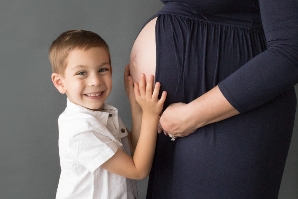 Big brother proudly holds moms pregnant tummy and wants to meet his new sister