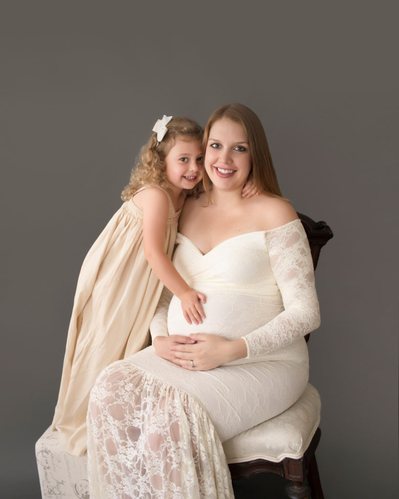 Morgan and daughter Sydney dressed in coordinating cream gowns for maternity photos