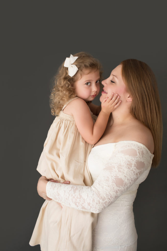 Morgan and daughter Sydney dressed in coordinating gowns for maternity photos pretty eyes to camera