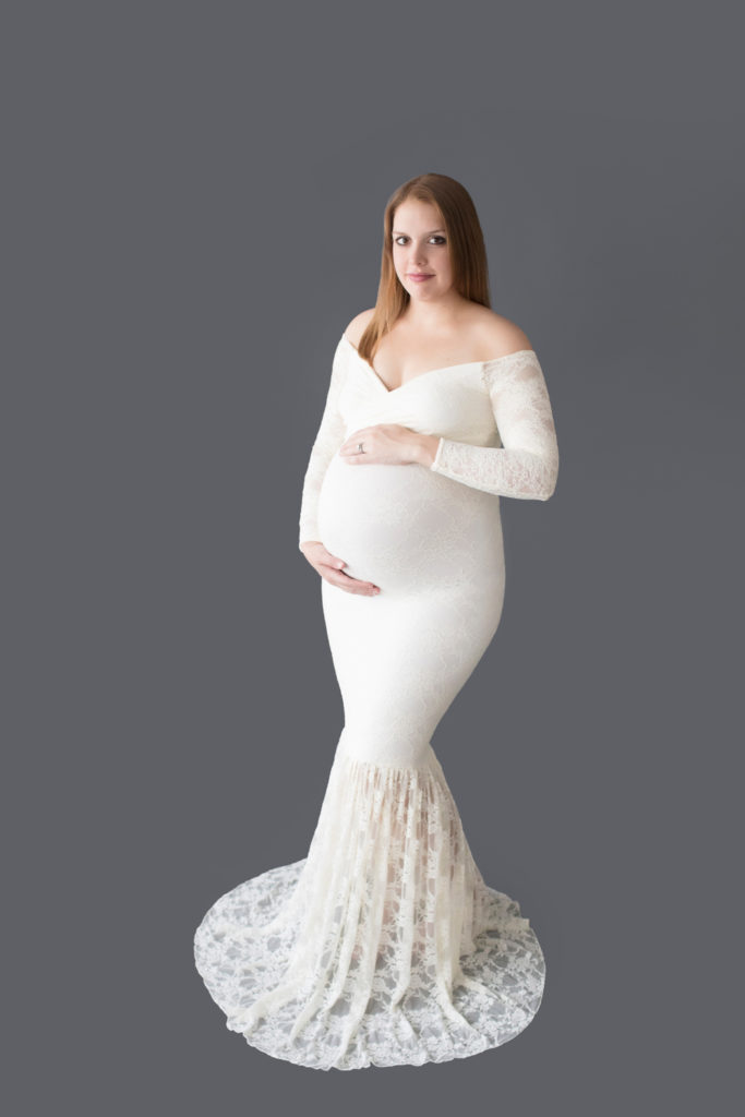 Morgan dressed in lace mermaid maternity gown formal standing pose