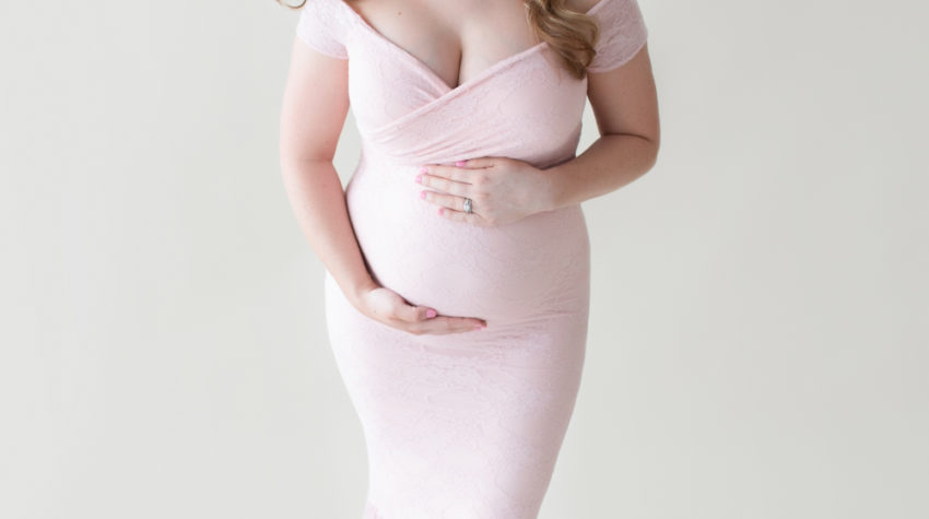 Maternity photos Christina posed fashion cover girl style showing beautiful belly bump wearing mermaid style full length pale pink lace gown Maternity Baby Photographer FL Gainesville