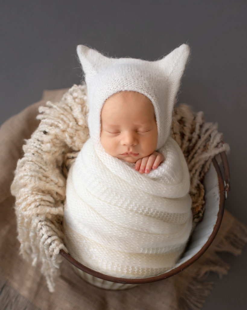 Newborn Baby Rowan wrapped in white potato sack posed in bucket Gainesvile Florida Photos