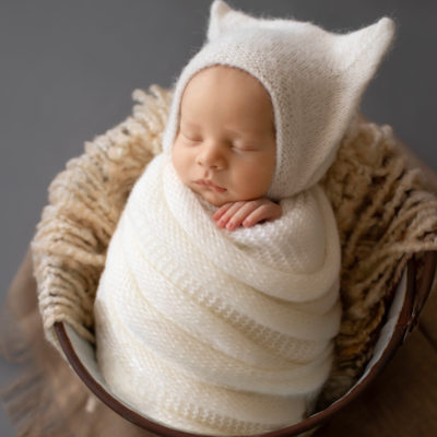 Newborn Photos Baby Rowan wrapped in white knit potato sack posed in bucket Gainesvile Florida Photos