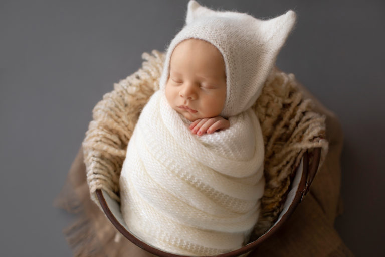 Newborn Photos Baby Rowan wrapped in white knit potato sack posed in bucket Gainesvile Florida Photos