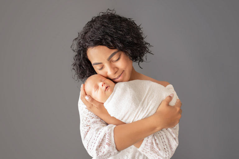 Big sister cuddling newborn baby Rowan Gainesvile Florida Newborn Photos