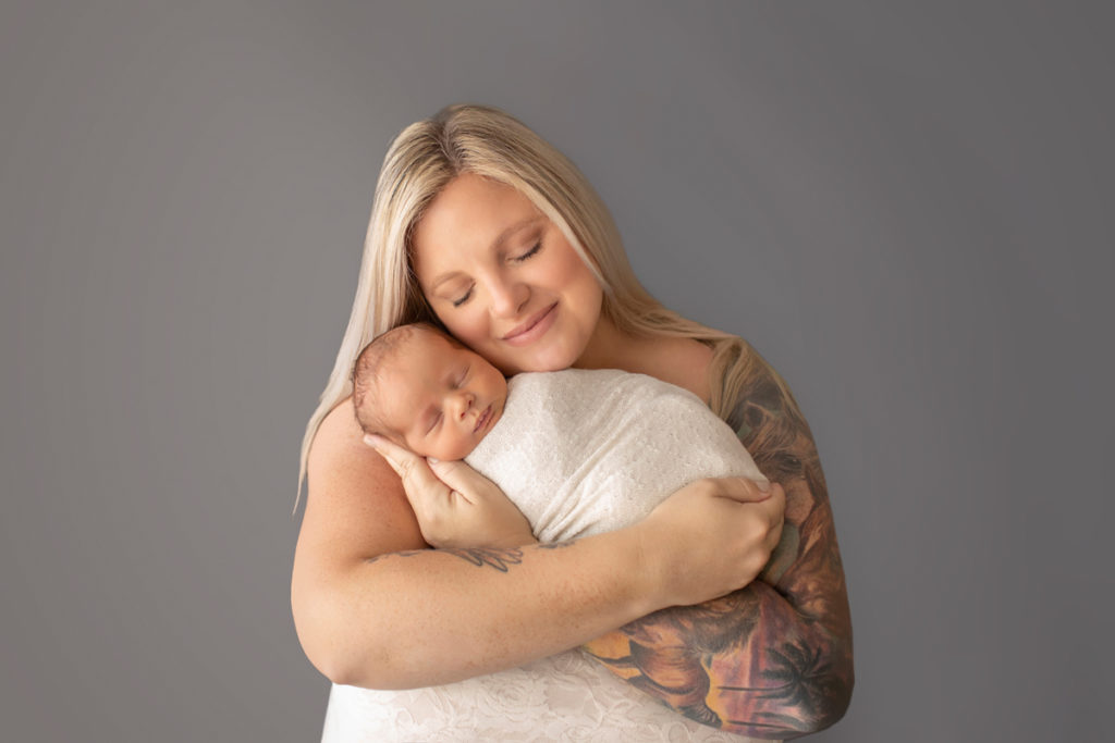 Mom with arm tatoo cuddling newborn baby Rowan Gainesvile Florida Photos