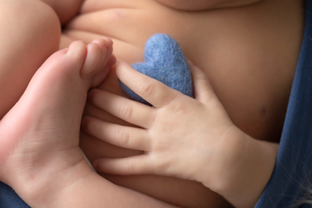 Newborn Baby Rowan close up hands holding tiny blue felt heart in hand Gainesvile Florida Photos