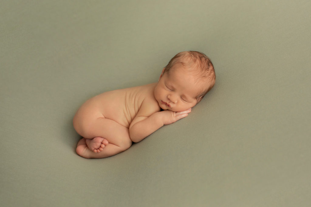  Newborn baby Rowan posed bottom up on green blanket Gainesvile Florida Photos