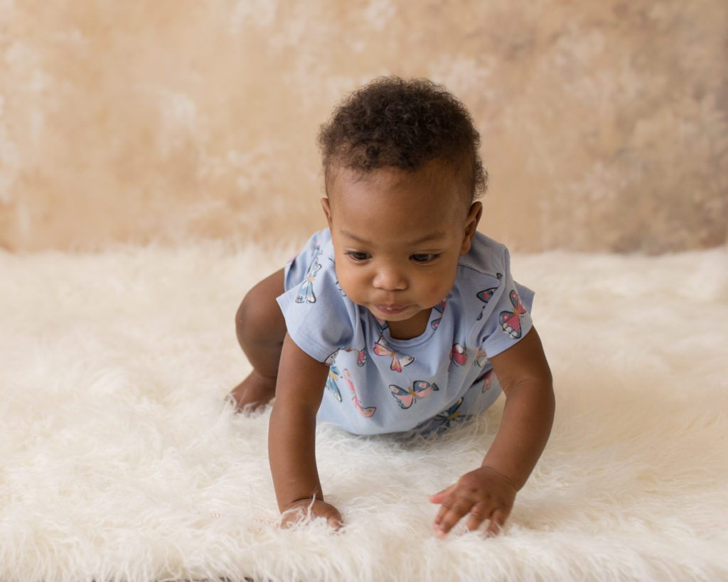 Rose One Year Old Baby Photos pink and peach tones crawling with blue dress Gainesville Florida