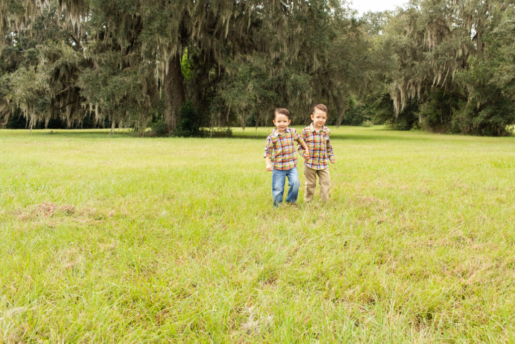 Family Photos with Three Year Old Twin Boys hand in hand running through field at Horseshoe Farm Alachua Florida-2