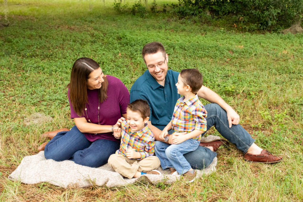 Family Photos with Three Year Old Twin Boys sitting on blanket and laughing at Horseshoe Farm Alachua Florida