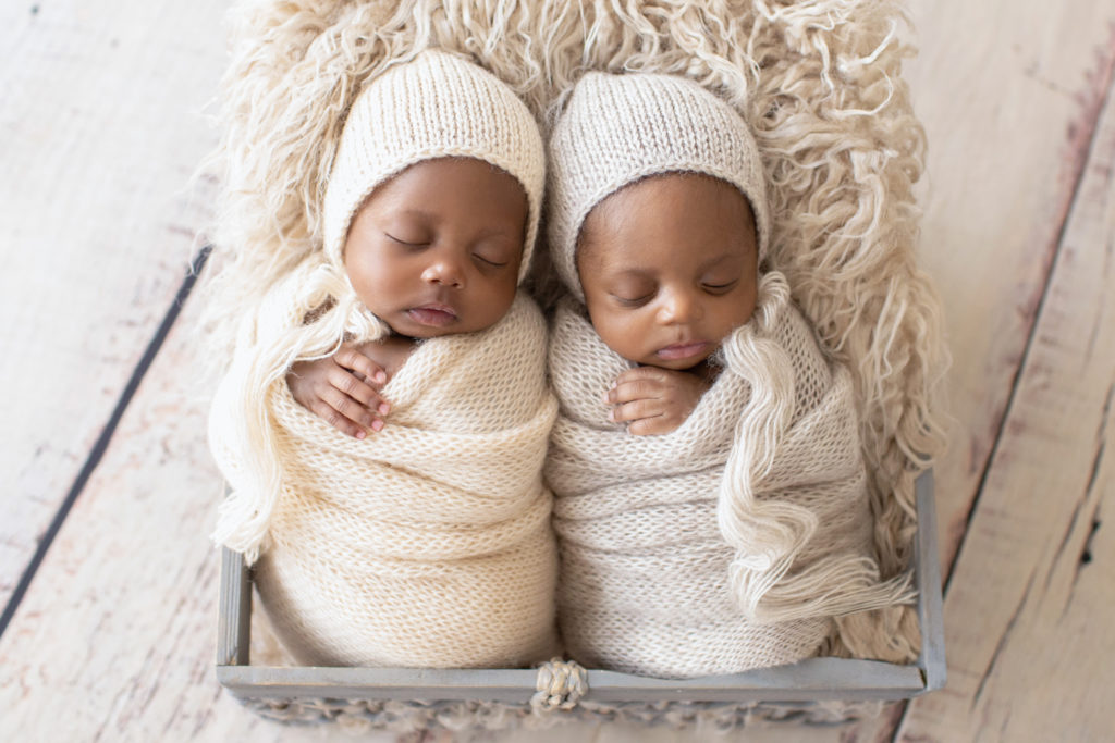 Twin Newborns Samuel and Sophia matching potato sack beige knit and wraps and bonnets fur stuffed basket Gainesville Florida newborn photos
