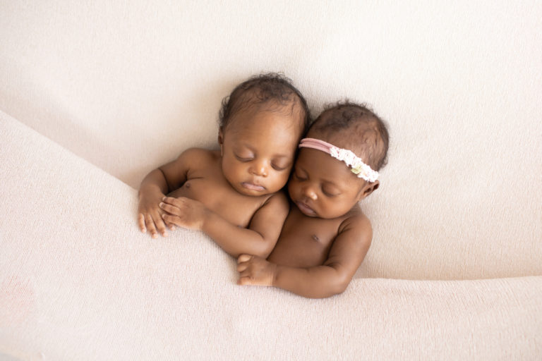 Twin Newborns Samuel and Sophia sleeping snuggling tucked into cream blanket Gainesville Florida newborn photos