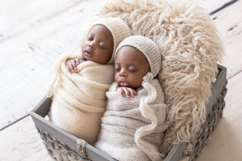 Twin Newborns Samuel and Sophia matching potato sack beige knit wraps and bonnets fur stuffed basket Gainesville Florida backlight newborn photos
