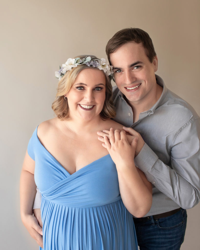 Maternity couple Katie in light blue draped maternity gown with floral crown and husband Ben in denim and grey Gainesville Florida Maternity portraits