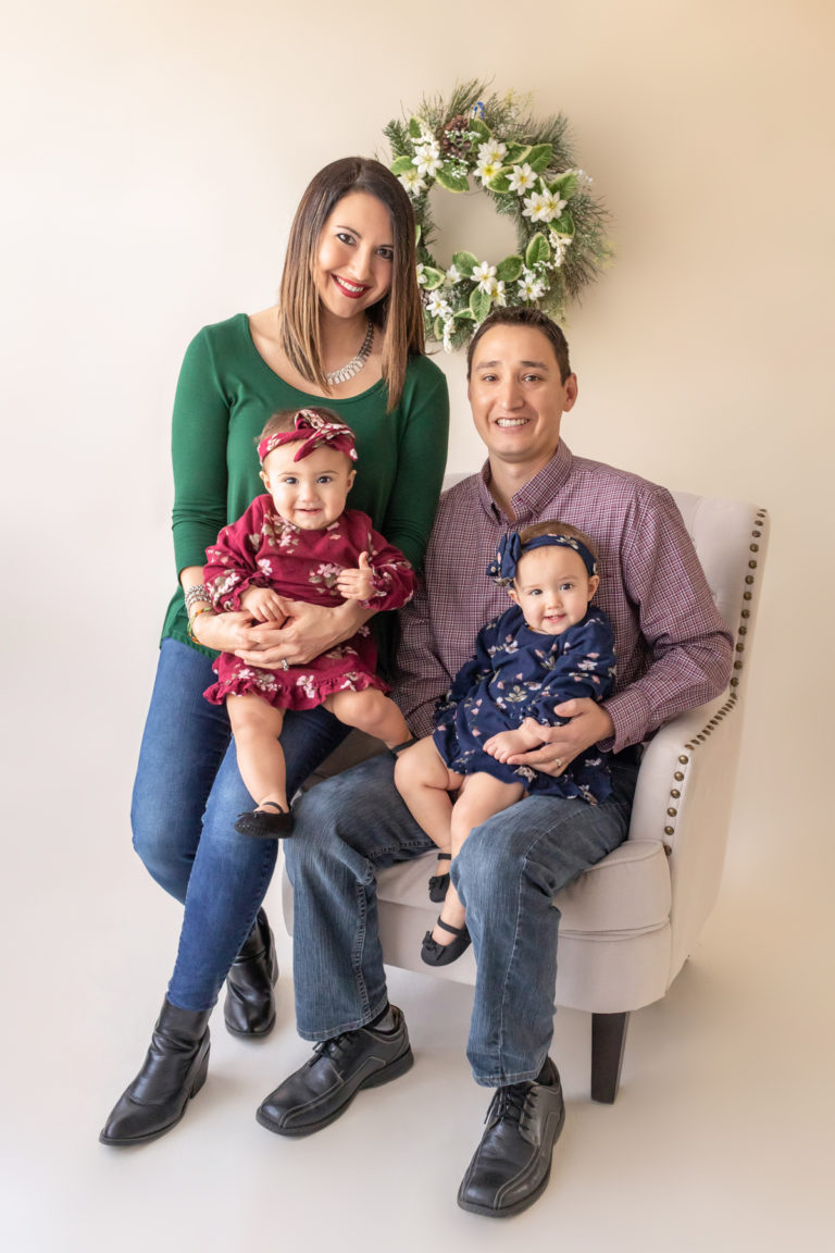 One year twin baby girl holiday photo with family dressed in emerald tones burgundy, green, navy for Christmas Gainesville Florida