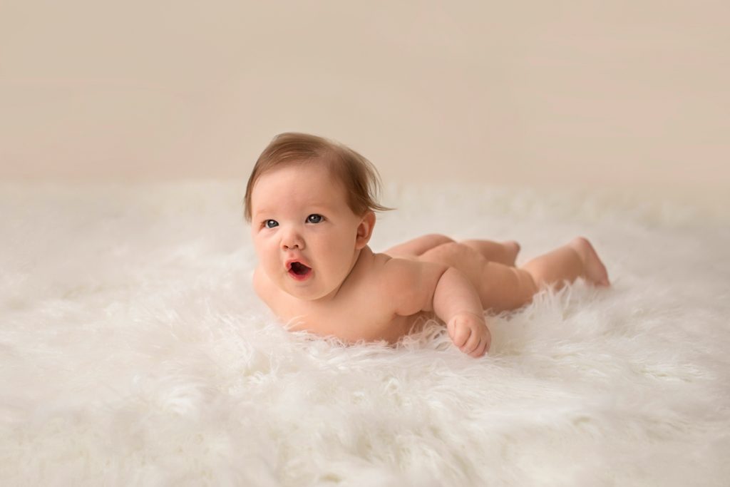 Garrett posed naked soft baby skin playful excited baby on soft white fur